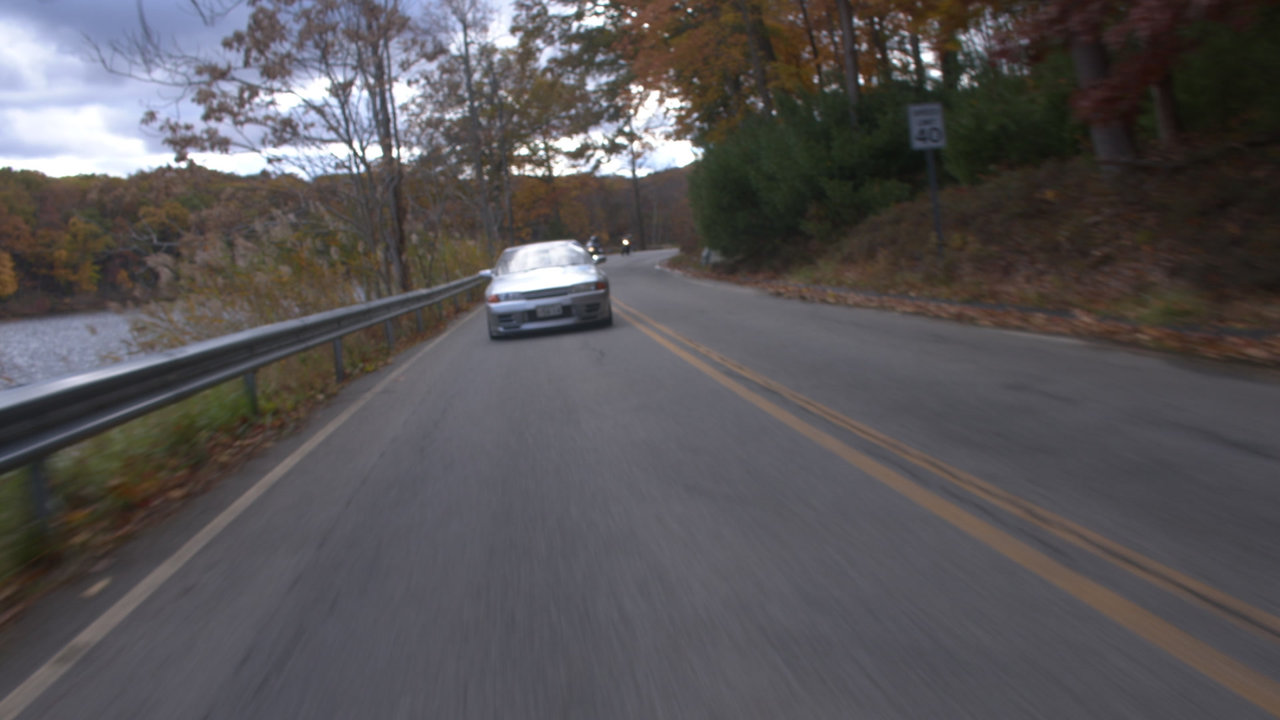 A silver Skyline on a tree-lined road, from the ETC Cinema portfolio